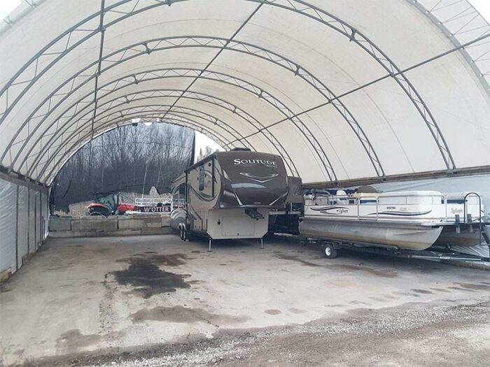 Outdoor storage, inside view with boat and trailer